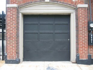 red brick black roll up garage door